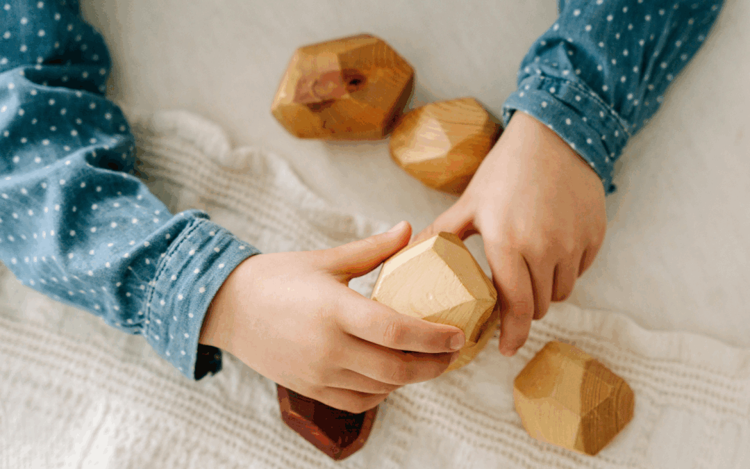 kid handling wood toys